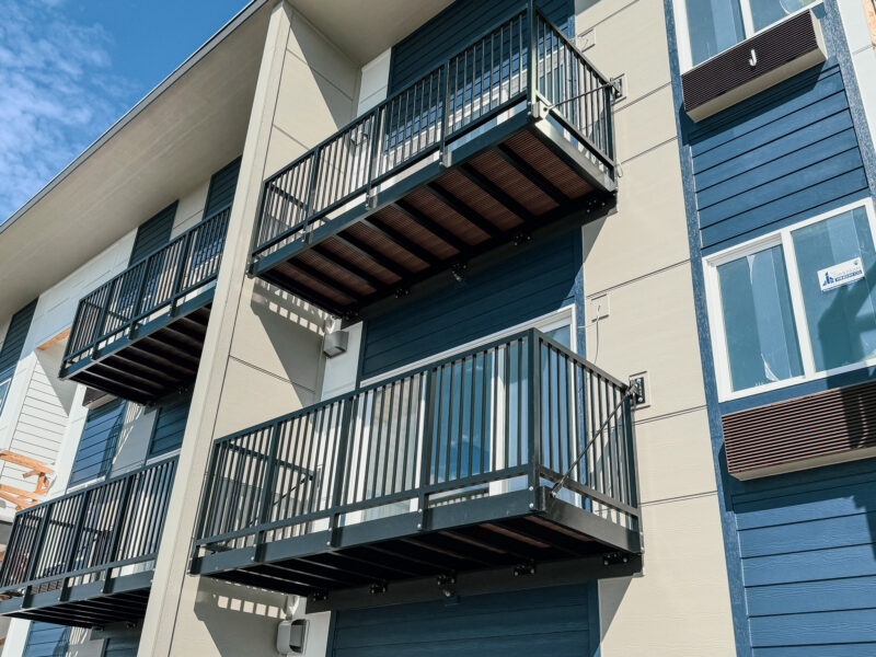 Multiple Aluminum Bolt-On Balconies attached to a multifamily apartment building in a coastal area